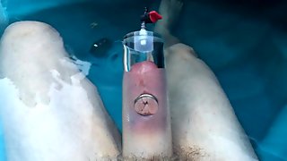 Pumping cock foreskin and balls in hot tub